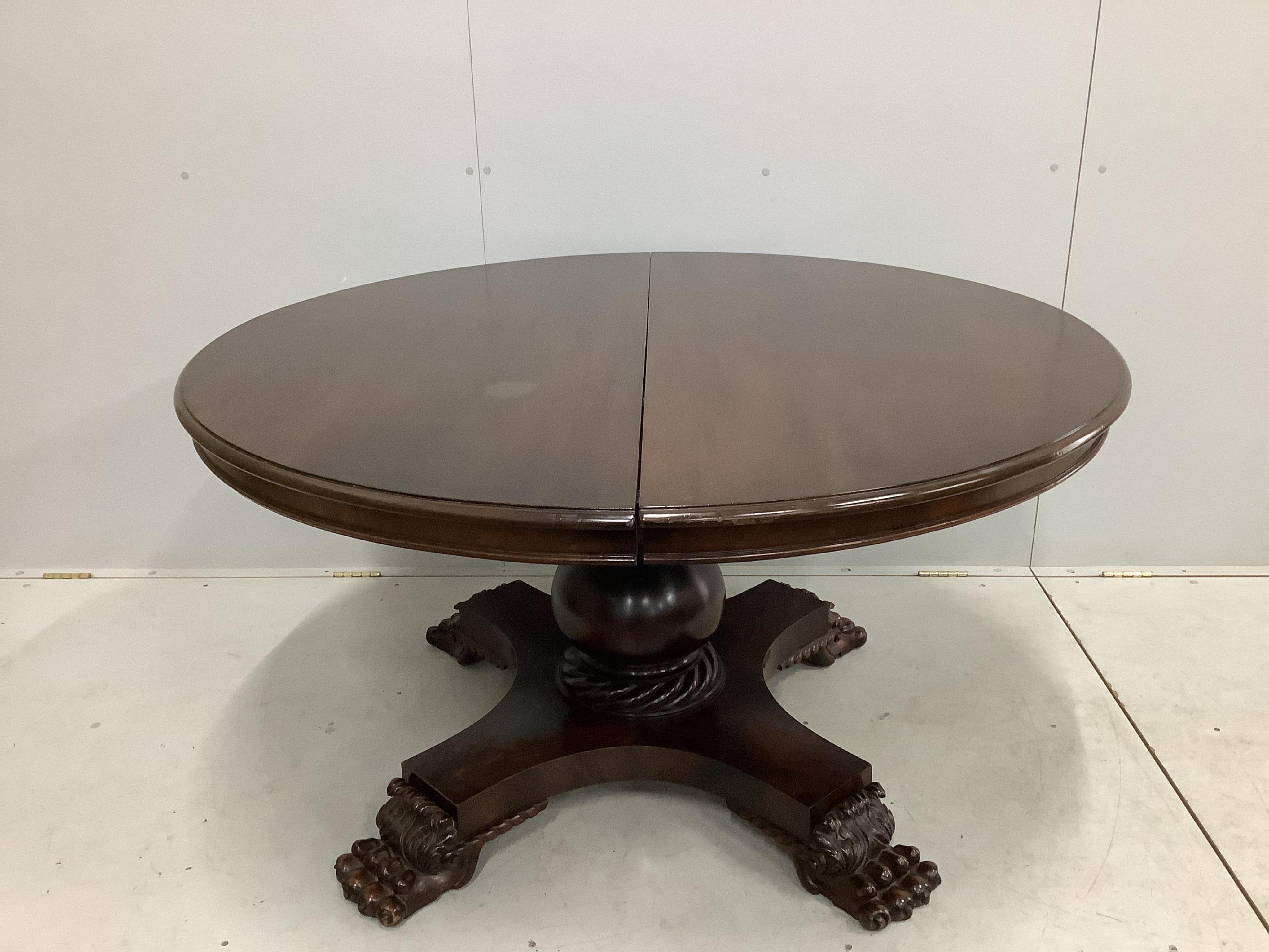 A George IV style circular mahogany extending dining table, 224cm extended, two spare leaves, width 134cm, height 74cm. Condition - fair to good